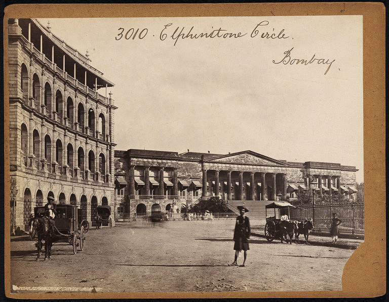 Photograph captioned Elphinstone Circle, Bombay, showing the arcaded buildings of the new circle