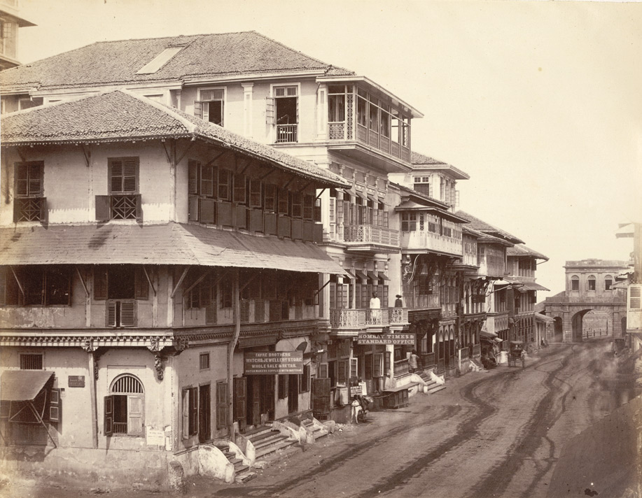 A street in Bombay in the 1860s, lined with balconied buildings